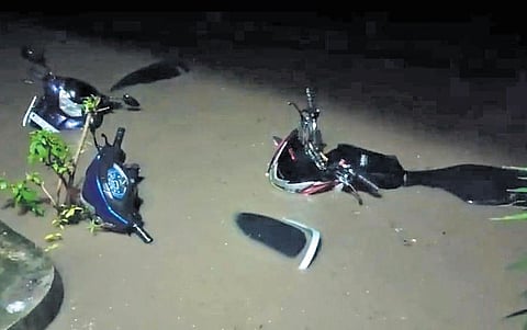 Two-wheelers submerged in Kagaznagar town as low-lying areas were flooded in Kumurambheem-Asifabad district on Thursday