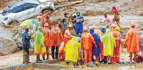 Rescue personnel take members of a family, who were affected by the landslide at Chooralmala, to safety on Tuesday