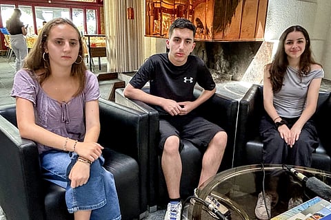 From left, Ary Hammerman of White Plains, New York, Ali Salman from Ghajar, in the Golan Height, and Tina Shammas of Nazareth in the West Bank, pose for a photograph after an interview as part of a Geneva junket for the Jerusalem Peacebuilders program in Geneva, Switzerland, Thursday, July 25, 2024.