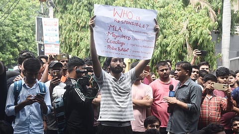 Angry students protest the deaths of three civil service aspirants after the basement of a coaching centre was flooded following heavy rain, in New Delhi, Sunday, July 28, 2024.