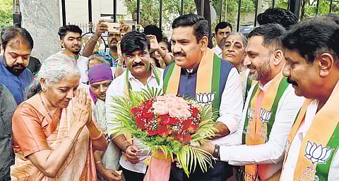 BJP state chief BY Vijayendra and party workers welcome Union Finance Minister Nirmala Sitharaman to the party office in Bengaluru on Sunday