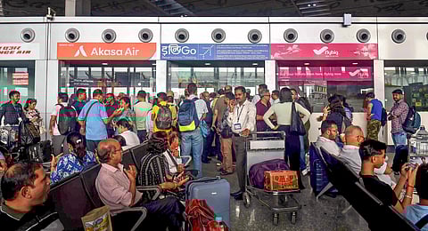 Passengers wait at the NSCBI Airport as check-in syastem was affected amid the Microsoft outage, in Kolkata, Fiday, Jul 19, 2024.