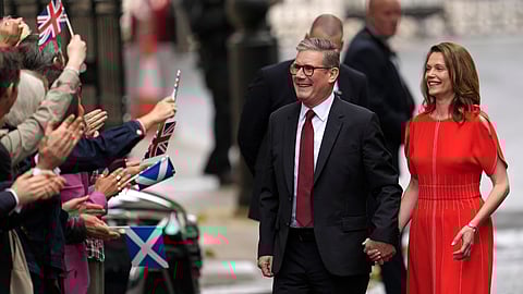 Britain's Labour Party Prime Minister Keir Starmer and his wife Victoria arrive in Downing Street and greet supporters in London, Friday, July 5, 2024.