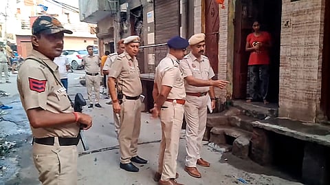 Police personnel outside the house of a 28-year-old gym owner who was stabbed to death by a group of men on Wednesday night at Gamri Extension.