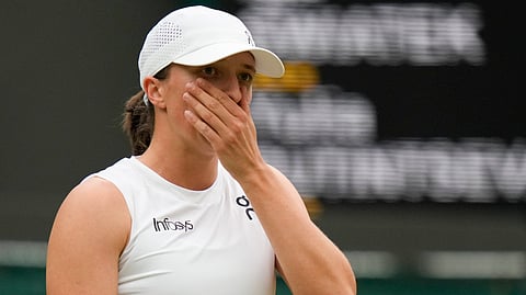 Iga Swiatek of Poland reacts during her third round loss to Yulia Putintseva of Kazakhstan at the Wimbledon tennis championships in London, Saturday, July 6, 2024.