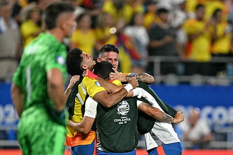Colombia's forward Luis Diaz (2nd L) and Colombia's midfielder James Rodriguez (C) celebrate their team's victory as Uruguay's goalkeeper #01 Sergio Rochet reacts in defeat during the Conmebol 2024 Copa America tournament semi-final football match between Uruguay and Colombia