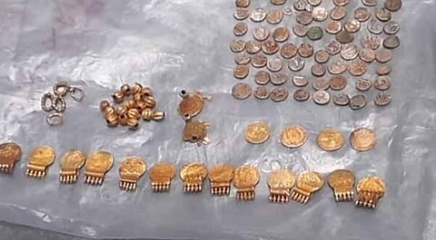 Inside the container, there were 17 pearl beads, 13 gold medallions, four medallions believed to be part of a traditional ornament called Kashi Mala, a set of earrings, rings, and silver coins.