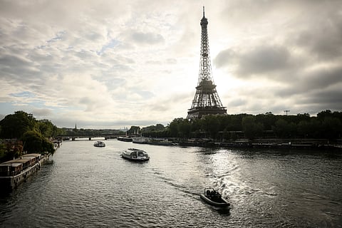 Barges cruise on the Seine River near the Eiffel Tower during a rehearsal for the 2024 Paris Olympic opening ceremony.