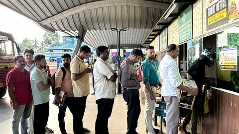 People wait in front of the KSRTC courier service at Vyttila Mobility Hub in Kochi.