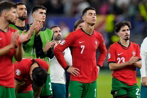 Portugal's Cristiano Ronaldo, center, reacts at the end of a quarter final match against France at the Euro 2024