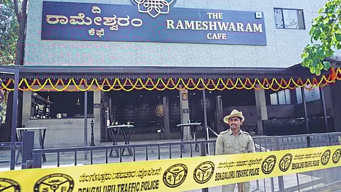 A police personnel on guard at Rameshwaram Cafes Brookfield branch, a day after a bomb blast at the cafe in Bengaluru