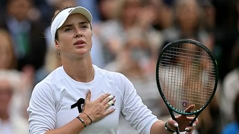 Tearful day: Elina Svitolina wears a black ribbon in her win over China's Wang Xinyu.