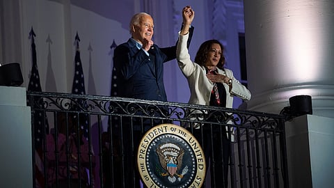 President Joe Biden raises the hand of Vice President Kamala Harris after viewing the Independence Day fireworks display over the National Mall from the balcony of the White House, Thursday, July 4, 2024, in Washington.