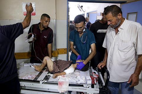 A Palestinian boy wounded in the Israeli bombardment of the Gaza Strip is treated in a hospital in Khan Younis, Tuesday, July 9.