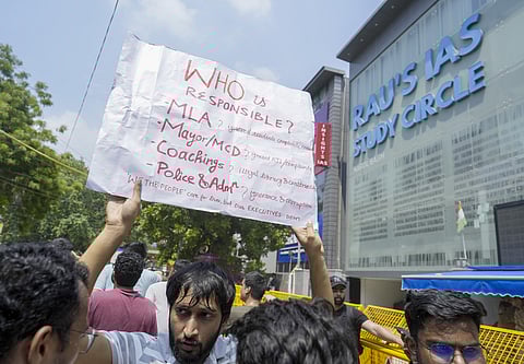 FILE - A student during a protest after three civil services aspirants died due to drowning at a coaching centre in Old Rajinder Nagar area.