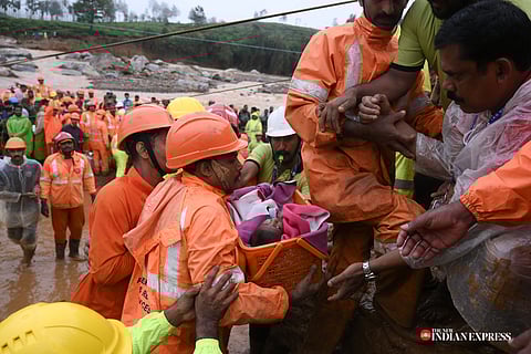 An infant being rescued by the National Disaster Relief Force team from the landslide-affected Mundakkai in Wayanad.