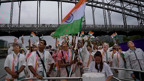 Indian athletes wave their national flags from a boat on the Seine River in Paris, France, during the opening ceremony of the 2024 Summer Olympics, Friday, July 26, 2024.