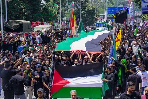 Shia mourners carry the Palestinian flag while raising the issue of Israel-Gaza war, as they participate in the 8th Muharram procession, in Srinagar, Monday, July 15, 2024.
