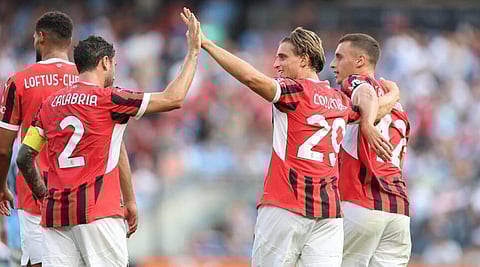 AC Milan's Lorenzo Colombo, at centre right, high-fives a teammate to celebrate scoring a goal in the Italian club's 3-2 victory over Manchester City.