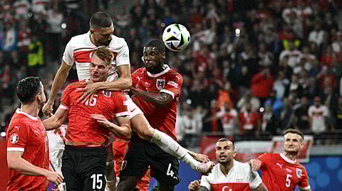 Turkey's defender Merih Demiral (C) heads the ball and scores his team's second goal during the UEFA Euro 2024 round of 16 football match between Austria and Turkey on July 2, 2024.