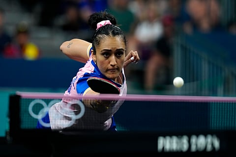 India's Manika Batra plays against Romania's Adina Diaconu during a women's teams round of 16 table tennis match at the 2024 Summer Olympics.