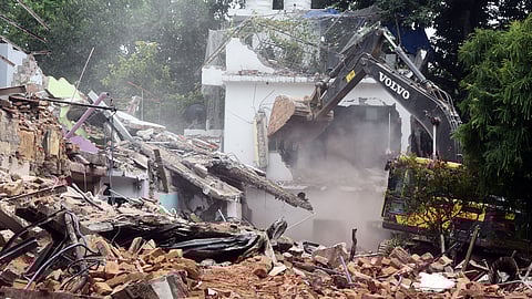 Houses being bulldozed during a demolition drive at Khyber Pass area, in New Delhi on Sunday, Aug. 4, 2024.