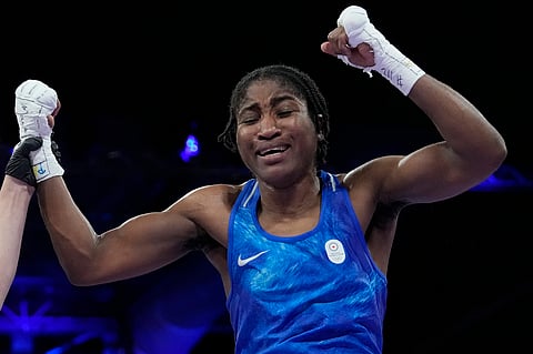 Refugee Olympic Team's Cindy Djankeu celebrates after defeating Canada's Tammara Thibeault in their women's 75 kg preliminary boxing match at the 2024 Summer Olympics, Wednesday, July 31, 2024, in Paris, France.