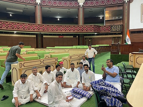 Raising slogans, Congress members then sat on a dharna in the Well of the House even after the chairperson announced an adjournment for the day.