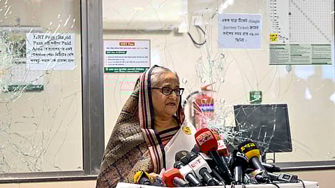 In this handout photograph taken and released on July 25, 2024 by Bangladesh Prime Minister's Office, Prime Minister Sheikh Hasina addresses the media at a vandalized metro station in Mirpur, after the anti-quota protests.