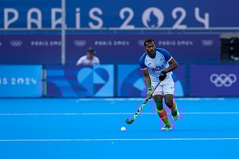 India's Amit Rohidas drives the ball during the men's quarterfinal field hockey match between Britain and India at the Yves-du-Manoir Stadium during the 2024 Summer Olympics.