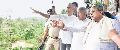 Karnataka Chief Minister Siddaramaiah inspects a flood-affected area in Ponnampet taluk of Kodagu district on Friday