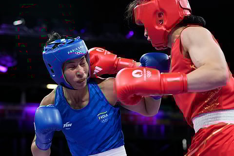 China's Li Qian, right, fights India's Lovlina Borgohain in their women's 75 kg quarterfinal boxing match at the 2024 Summer Olympics on Sunday.