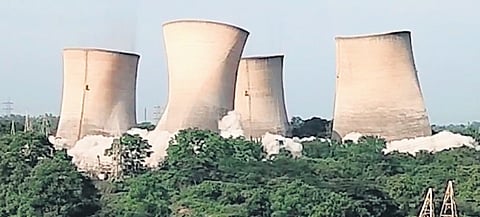 Workers demolish the eight outdated cooling towers in KTPS using implosion technology in Palvoncha town on Monday