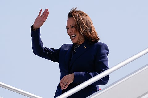 Vice President Kamala Harris waves to supporters during her arrival in Houston on Wednesday, July 31, 2024.