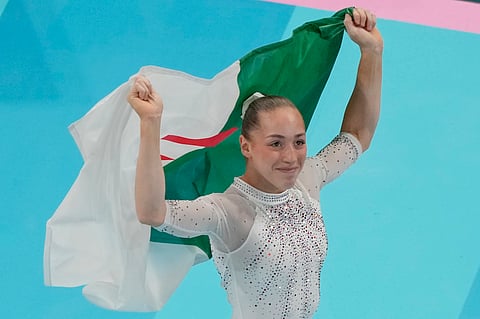 Kaylia Nemour, of Algeria, reacts after winning the gold medal during the women's artistic gymnastics individual uneven bars finals in Bercy Arena at the 2024 Summer Olympics, Sunday, Aug. 4, 2024, in Paris, France.