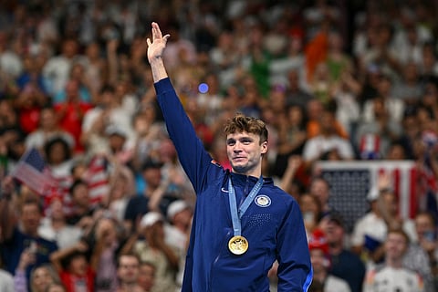 Gold medallist US' Bobby Finke poses with the gold medal after winning the men's 1500m freestyle swimming event during the Paris 2024 Olympic Games on August 4, 2024.