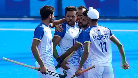 India's Harmanpreet Singh, second left, celebrates with teammates after scoring the opening goal during the men's quarterfinal field hockey match between Britain and India at the Yves-du-Manoir Stadium during the 2024 Summer Olympics