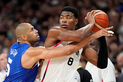 France's Nicolas Batum, left, reaches in on Japan's Rui Hachimura in a men's basketball game at the 2024 Summer Olympics, Tuesday, July 30, 2024, in Villeneuve-d'Ascq, France.