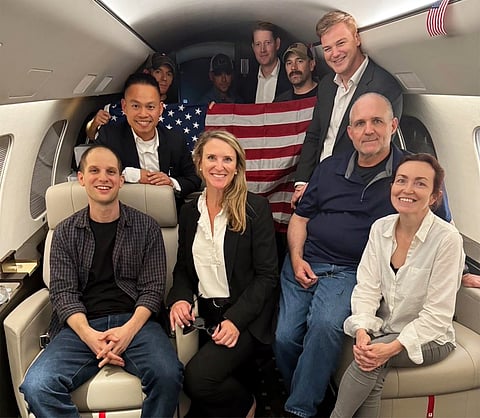 This image released by the White House shows Evan Gershkovich, left, Alsu Kurmasheva, right, and Paul Whelan, second from right, and others aboard a plane, Thursday, Aug. 1, 2024, following their release from Russian captivity.
