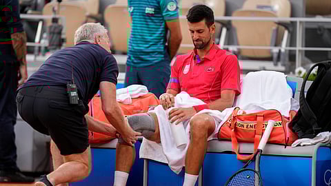 Serbia's Novak Djokovic receives medical treatment during his match against against Stefanos Tsitsipas of Greece during their men's quarter-final match at the Roland Garros stadium.