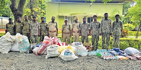 Forest dept officials collect plastic material from shops in Srisailam