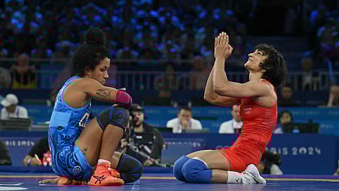 India's Vinesh Phogat (R) reacts her win over Cuba's Yusneylis Guzman Lopez (L) in their women's freestyle 50kg wrestling semi-final match at the Champ-de-Mars Arena during the Paris 2024 Olympic Games, in Paris on August 6, 2024.