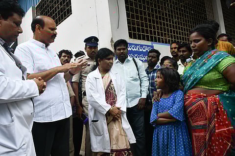 Minister Kolusu Parthasarathi interacting with the helpers of patients at the old GGH after they raised complaints about the poor maintenance of washrooms in Vijayawada on Tuesday.