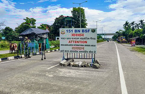 A Border Security Force (BSF) personnel stands guard at the India-Bangladesh border checkpost at Fulbari near Siliguri.