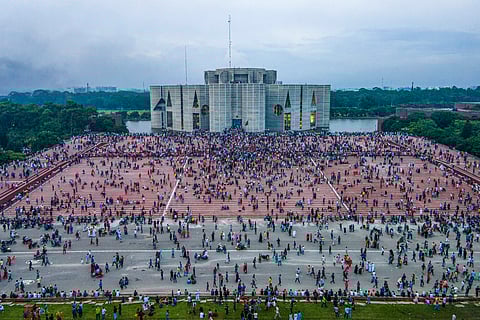 A photo taken with a drone shows people gather around at the Bangladesh Parliament House in Dhaka, Bangladesh, 05 August 2024.