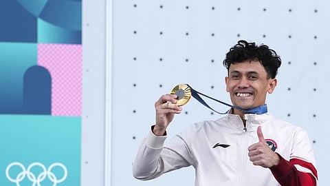 Gold medallist Veddriq Leonardo of Indonesia poses after winning the men's speed final during the sport climbing competition at the 2024 Summer Olympics.