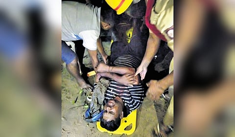 Rescuers attend to truck driver Bala Murugan, who survived the bridge collapse in Karwar on Wednesday