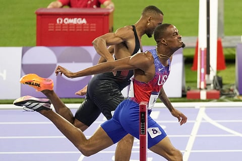 Quincy Hall, of the United States, crosses the finish line followed by Matthew Hudson-Smith, of Britain, in the men's 400-meters final at the 2024 Summer Olympics, Wednesday, August 7, 2024, in Saint-Denis, France,