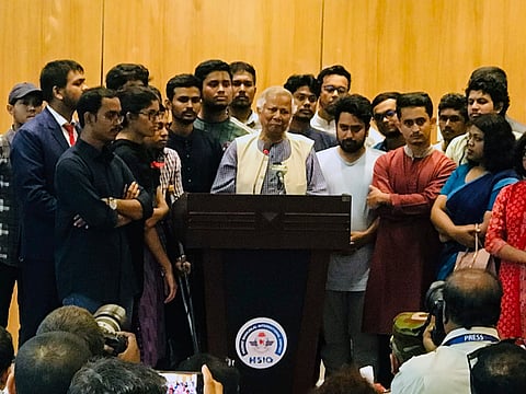 Nobel laureate Muhammad Yunus speaks to the media at the airport as he arrives in Dhaka, Bangladesh, Thursday, Aug. 8, 2024.