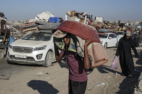 A Palestinian youth flees the Khan Younis area of the Gaza Strip, following Israeli military evacuation orders saying its forces will soon operate there, Thursday, August 8, 2024.